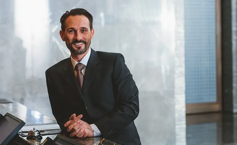 Man in a business suit stops building blocks from falling